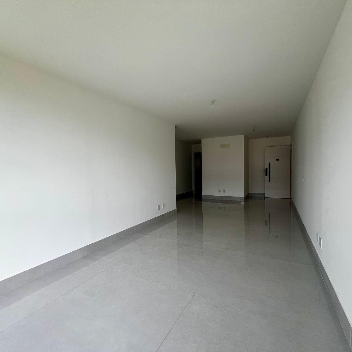 Ambiente interno da sala com piso claro e paredes brancas
