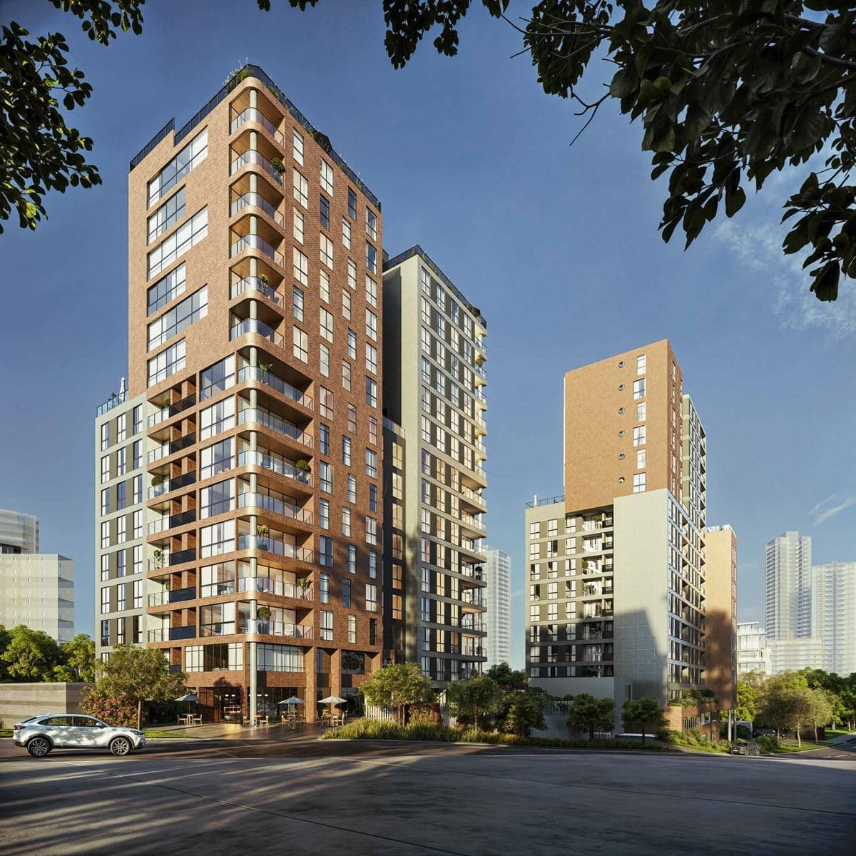 Fachada externa de complexo residencial com torres de múltiplos andares revestidas em tijolinho à vista e varandas.